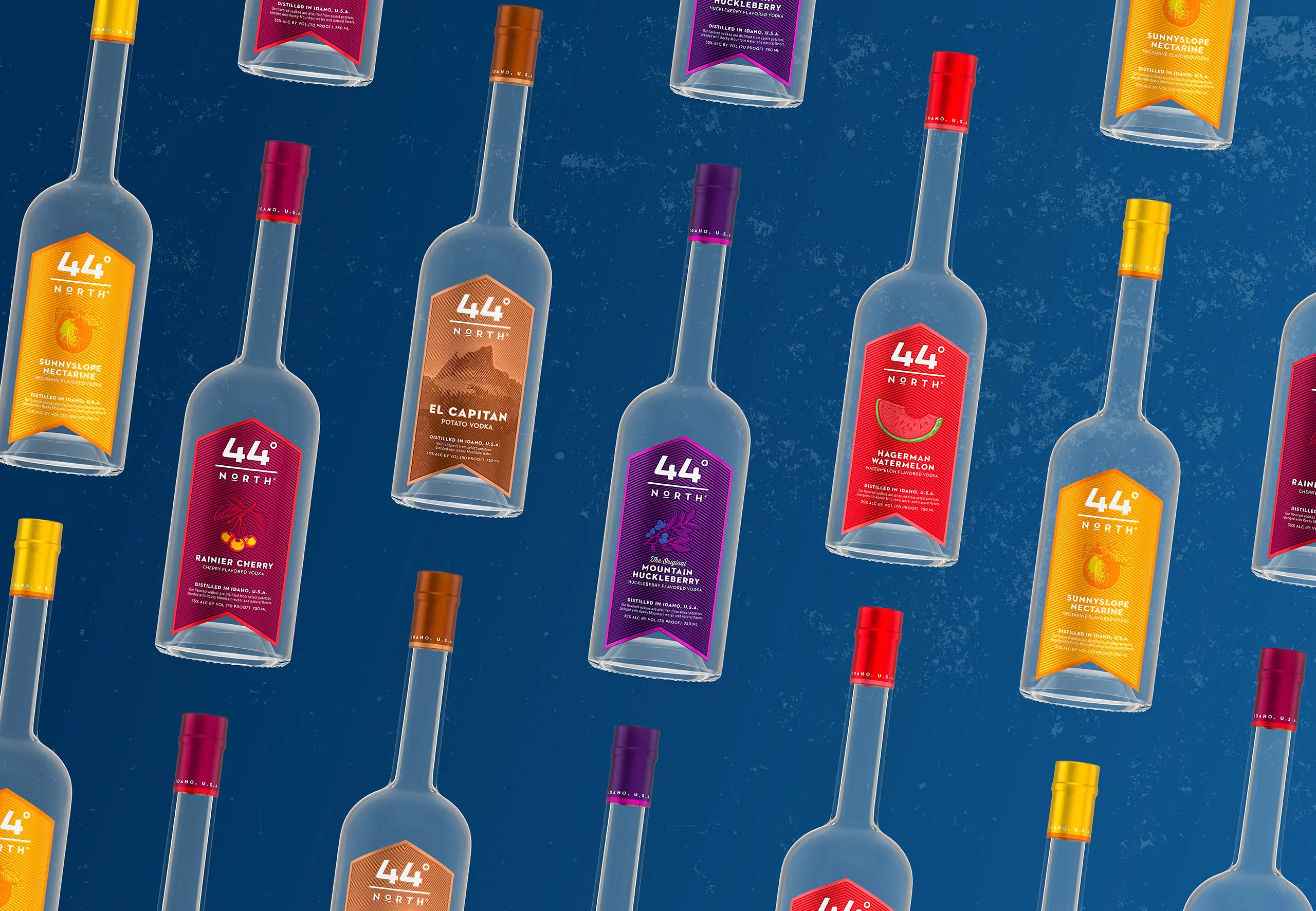 Assorted 44° North vodka bottles featuring multiple flavors arranged in a repeating pattern on a textured blue background.